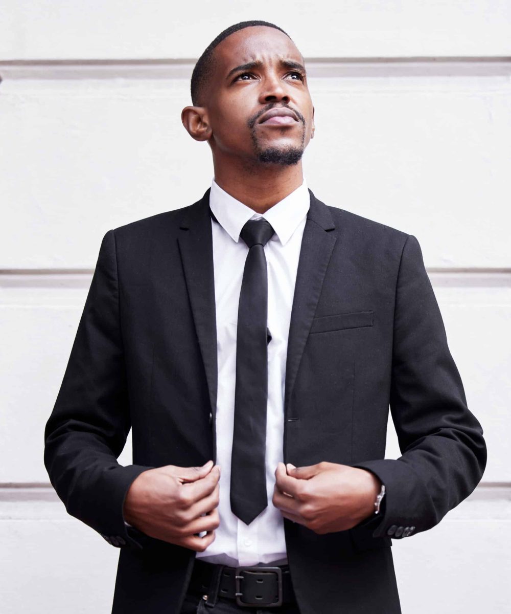 Cropped shot of a handsome young businessman looking dapper while standing outside in the city.